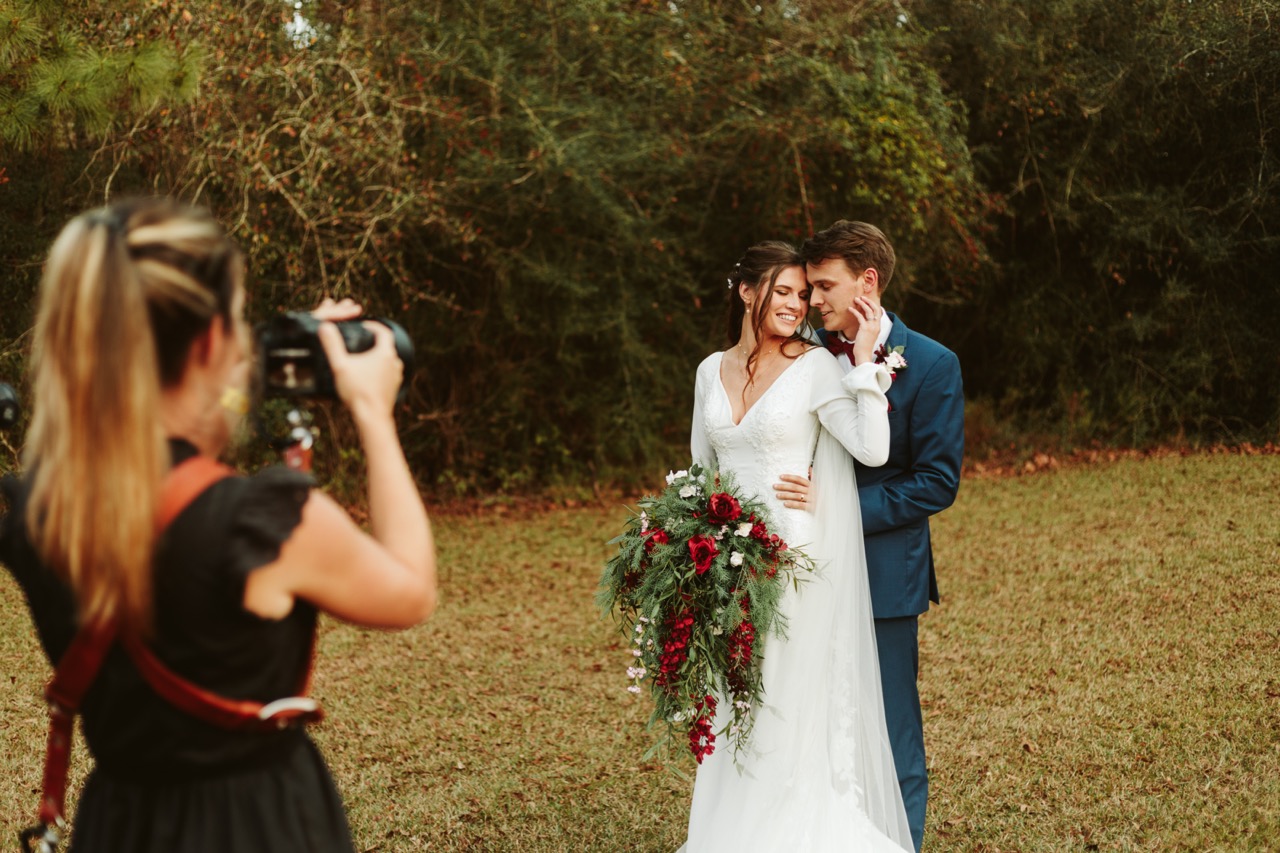 bride and groom being photographed by a photographer